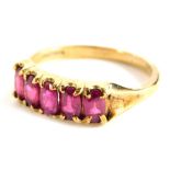 A 9ct gold dress ring, set with five rubies, in a claw setting, ring size O, 2.9g all in, boxed.