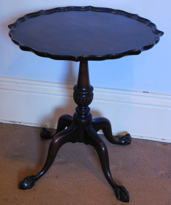 A Georgian mahogany style occasional table, with a pie crust top and four out splay legs, with ball