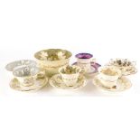 A group of Rockingham teawares, comprising three spur handle of flowers decorated cup and saucer pat