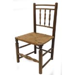 A 19thC oak and ash country made side chair, with a spindle turned back, woven seat on turned legs w