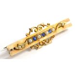 A Victorian 9ct gold bar brooch, on two bar design, with central panel set with sapphires and seed p