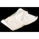 A pair of white flannel trousers, size 48 waist and 40 leg, signed by Brian May.