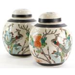 A pair of Chinese porcelain ginger jars, each decorated with famille enamels with insects, Asiatic p