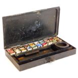 A late 19thC toleware artist's paint box, the hinged lid later written 'Tea' four times, enclosing t