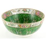 A Chinese Canton bowl, decorated with dragonflies, birds, flowers, in green and red, six character m