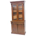 A Victorian walnut, pine and oak bookcase, the top with a moulded cornice with two glazed doors encl