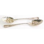 A matched pair of George III silver preserve spoons, Old English pattern, engine turned, raised berr