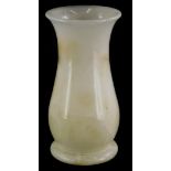 A turned white onyx baluster shaped vase, 25cm high.