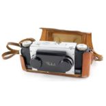 A Realist stereo twin lens camera, in a leather case.