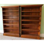 A pair of Edwardian oak open bookcases, with locking bars, 178cm high, 110cm wide.