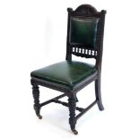 An early 19thC stained oak side chair, with a carved padded back and padded seat, on turned legs wit