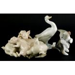 Three Lladro porcelain figures, to include a group of a pig with two piglets, a cat and mouse, and a
