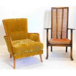 A mid 20thC French walnut armchair, upholstered in gold coloured material with loose cushion, on sha