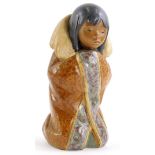 A Lladro porcelain figure of a kneeling Eskimo child, printed mark in blue to underside, 19cm high.