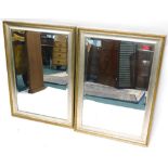 A pair of silvered and gilt wall mirrors, each with a rectangular plate, 107cm high, 75cm wide.
