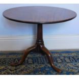 A George III mahogany occasional table, with circular tilt top, on gun barrel pillar and three outsp
