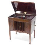 An early 20thC Columbia gramophone, in mahogany case with drawers containing 78 records and a centra