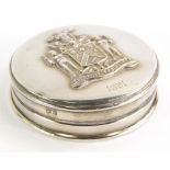 A George V silver powder case, of circular form with raised Loyalty and Liberty coat of arms and dat