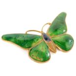 A continental Art Deco brass and enamel butterfly brooch, with green wings, unmarked, 6cm wide.