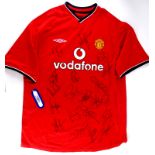A Manchester United football shirt, bearing signatures of various players, to also include the manag