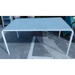 A metal framed garden table, with a slatted metal top.