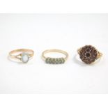 A 9ct gold and aquamarine solitaire ring, size R, 9ct gold and garnet cluster ring, size Q/R, and a