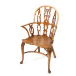 A Gothic style yew and elm Windsor chair, the hooped back with a shaped pierced splat flanked by fur