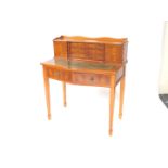A Sheraton revival Edwardian style yew wood desk, the galleried top raised above six drawers flanked