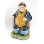 A Staffordshire type pottery figure modelled as Daniel Lambert, seated in his chair, 25cm high.