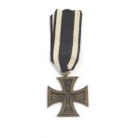 A German WWI Iron Cross, second class, with ribbon.