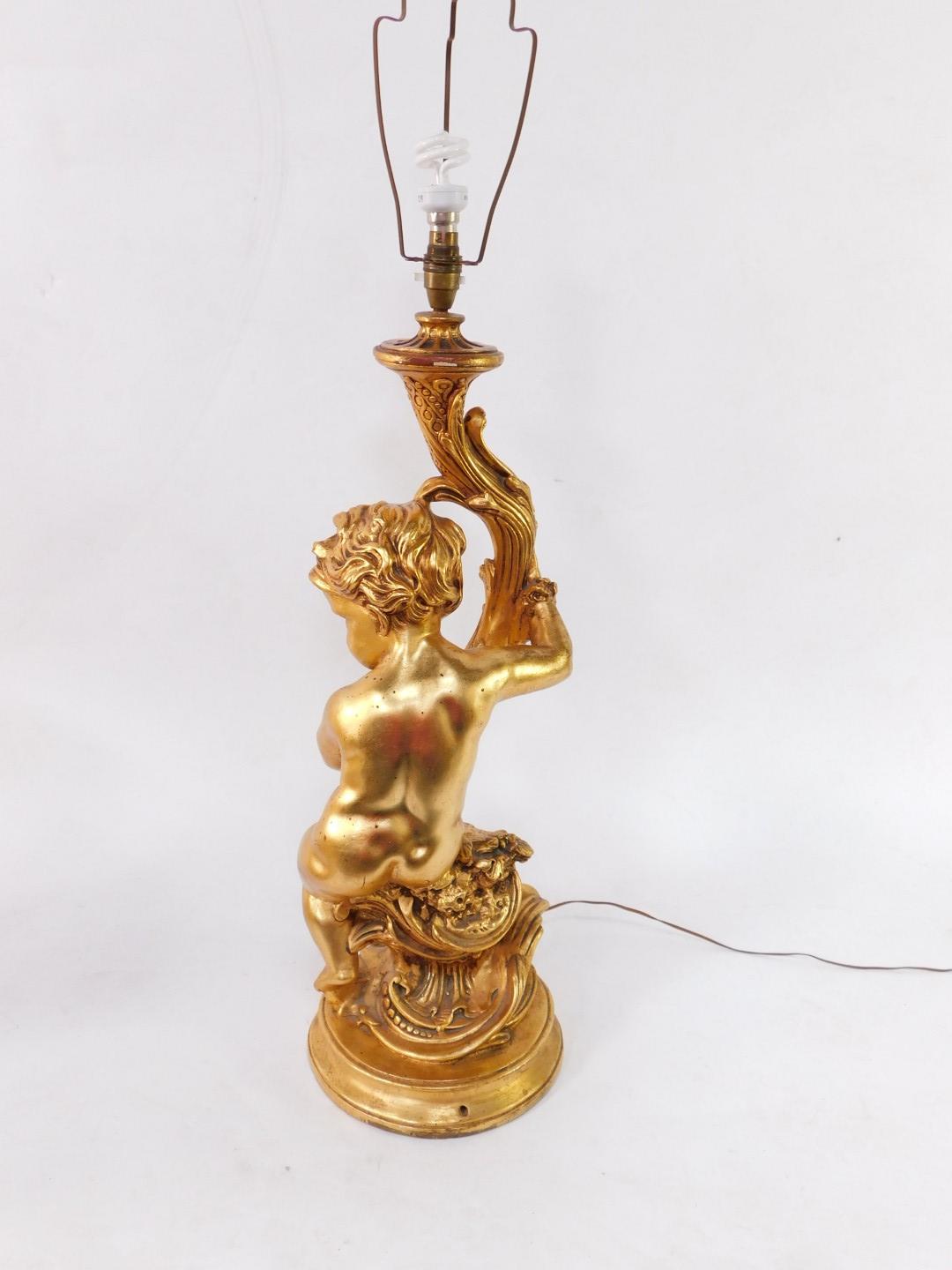 A 20thC plaster finish rococo table lamp, formed as a figure of a child, entwined stem, on a circula - Image 3 of 3