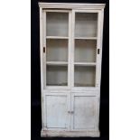 A 19thC painted pine kitchen cabinet, with fixed moulded cornice raised above two sliding three pane