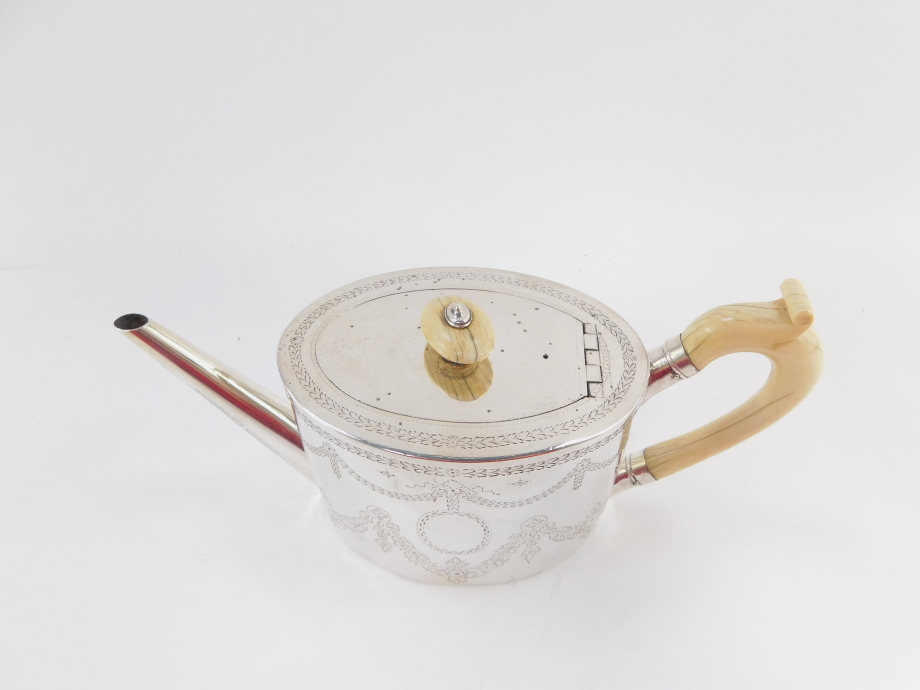 A Victorian silver teapot, the oval body with ivory handle and knop, plain spout, chased with garlan - Image 2 of 7