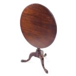 A George III mahogany bird cage tilt top table, the plain circular form raised above a bird cage act