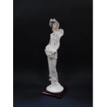 A Capo di Monte Florence figure of a lady, designed by Giuseppe Armani, modelled standing holding a