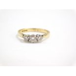 An 18ct gold and diamond three stone ring, approx 0.5cts, size O, 3.3g.