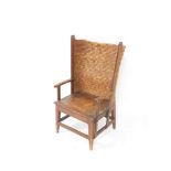 A traditional Orkney chair, with wing type curved back, shaped arms, plain seat, square tapering