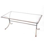 A 20thC glass top coffee table, of rectangular form, with iron frame on shaped legs, joined by a cyl