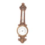 A Victorian oak cased aneroid barometer, with thermometer, carved with foliate scrolls, 88cm high.