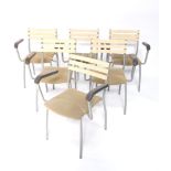 A set of six metal framed stacking chairs, with pressed leatherette arms, pierced melamine finish sp