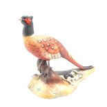 A Royal Crown Derby bisque porcelain figure modelled as a cock pheasant, by Y Harper, printed and pa