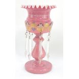 A 19thC pink glass lustre, with ribbon edged rim, painted body, baluster stem and circular foot with