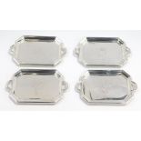 Four silver miniature trays, of twin handled octagonal form, engraved with the Flowers of the Four N