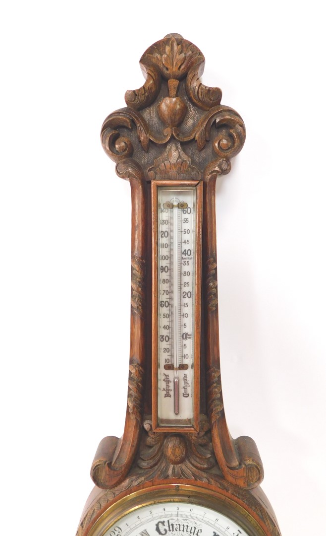 A Victorian oak cased aneroid barometer, with thermometer, carved with foliate scrolls, 88cm high. - Image 3 of 3