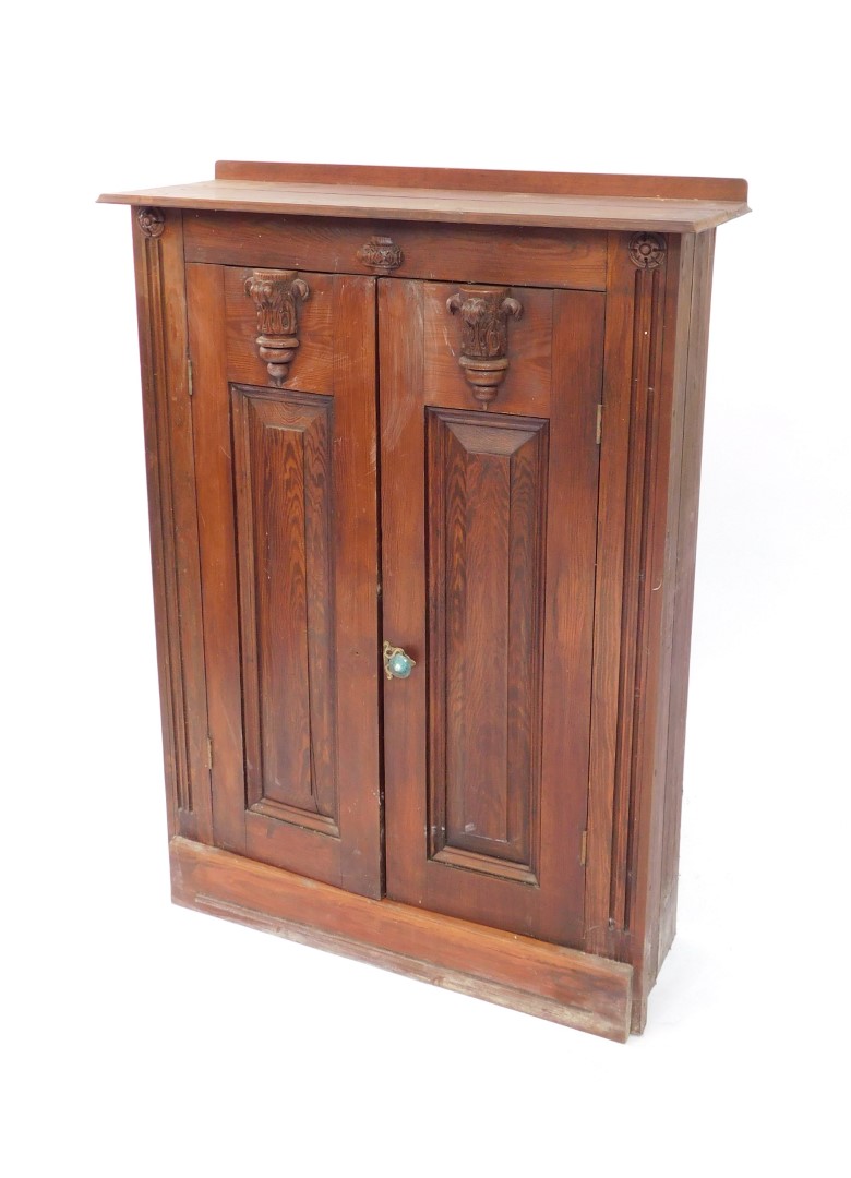 A 19thC ecclesiastical style pine vestment type cupboard, with carved semi circle acanthus leaf moul