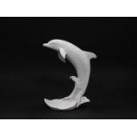 A Kaiser white matt bisque porcelain figure, modelled as a Dolphin, no 654., printed and impressed m