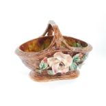 A late 19thC Continiental majolica basket, arranged with flowerheads and petals with inner mottled d