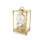 A Kundo German brass cased 400 day anniversary clock, circular silvered dial bearing Roman numerals,