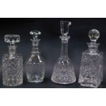 Four various 20thC crystal and other decanters, to include a mallet shaped example with shaped stopp
