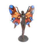 An Art Nouveau style bronzed figural fairy table lamp, moulded in standing pose with stained glass w